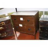 A PAINTED 19TH CENTURY CHEST OF TWO DRAWERS, standing on legs with a shaped skirt and four turned