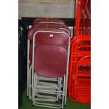 FIFTEEN SANDLER FOLDING CHAIRS, with burgundy moulded plastic seats and backs and grey tubular metal