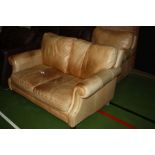 AN ANTIQUED FAWN LEATHER TWO PIECE SUITE, consisting of a two seater sofa (147cm wide) and an arm