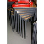 SIXTEEN MODERN STACKING SQUARE CLASSROOM TABLES, with beech effect tops over a tubular metal base (