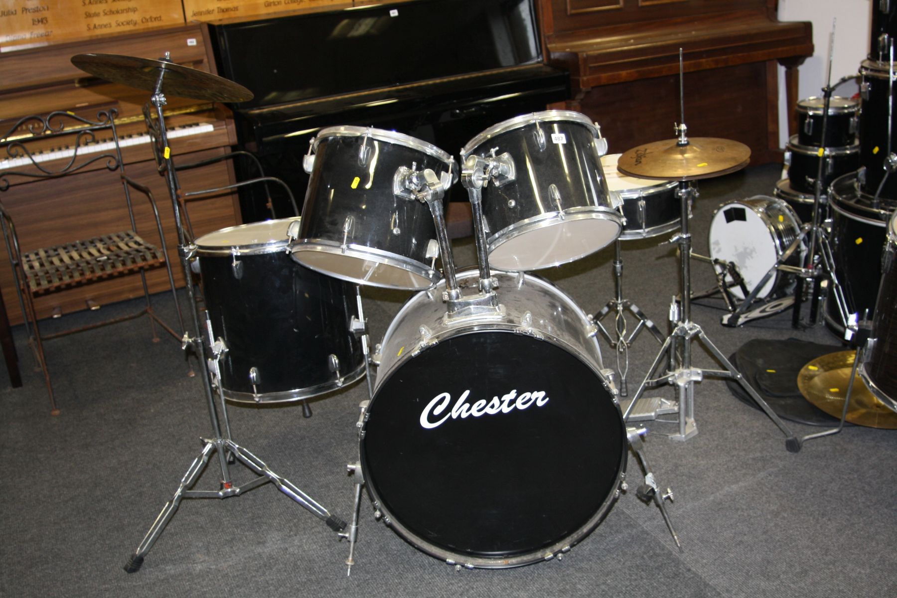 A CHESTER FIVE PIECE DRUM KIT, in black including 22''x15'' kick drum with pedal, a12''x9'' Tom, a