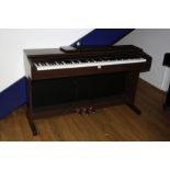 A YAMAHA ARIUS YDP-140 ELECTRONIC PIANO, with a Walnut effect case 135cm wide (s.d)