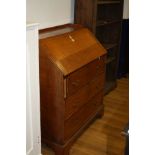 A GEORGIAN OAK BUREAU, with a plank oak fall front over three long drawers and brass swan neck