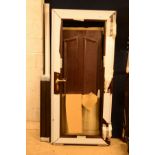 A ROSEWOOD EFFECT UPVC DOOR with brassed handles, height 195cm x width 89.5cm