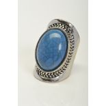 A WHITE METAL LARGE BLUE STONE RING, assessed as ceramic, ring size N