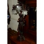 A REPRODUCTION FIGURAL RESIN TABLE LAMP with a triple branch light