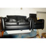 A BLACK LEATHER TWO SEATER SETTEE together with a black leather reclining armchair (2)