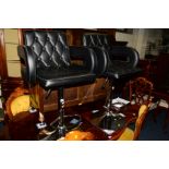 A PAIR OF BLACK BUTTONED LEATHER SWIVEL BAR CHAIRS/STOOLS on chrome bases