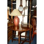 AN OAK BARLEY TWIST DROP LEAF TABLE, together with an oak aneroid barometer, corner whatnot and a