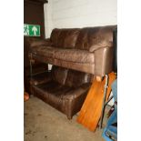 A BROWN LEATHER TWO SEATER SETTEE together with a matching smaller two seater settee (2)