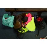 A COLLECTION OF EQUESTRIAN EQUIPMENT to include a saddle, reflective blankets, hats, lead, reigns,