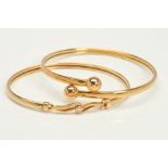 TWO 9CT GOLD BANGLES, the first of flexible torque design with spherical ball terminals, the