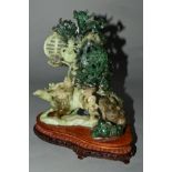 A CARVED GREEN HARDSTONE FIGURE GROUP OF DRAGONS AMONGST SCROLLS AND OTHER CHINESE DEVICES, probably