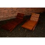 A PAIR OF TEAK SLATTED SUN LOUNGERS (2)