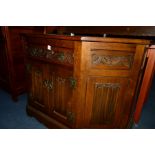 AN OLD CHARM OAK CANTED DOUBLE DOOR CABINET with a single drawer, width 109cm x depth 44cm x