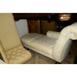 A CREAM UPHOLSTERED CHAISE LONGUE together with a smaller chaise longue (2)