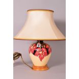 A MOORCROFT POTTERY TABLE LAMP BASE, with a shade, 'October Falling Leaves' pattern designed by