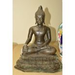 A MODERN BRONZED TYPE FIGURE OF A SEATED DEITY, approximate height 41cm x width 32cm x depth 15cm