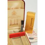 DUNHILL ROLLAGAS LIGHTER, gold plated case with an engine turned design, with replacement flints and