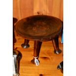 AN AFRIAN TRIBAL STYLE HARDWOOD STOOL, dished seat, raised on four cylindrical legs with pad feet,