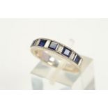 A SAPPHIRE AND DIAMOND HALF ETERNITY RING, designed as a channel set row of slightly graduated