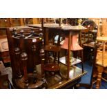 AN OAK CIRCULAR UMBRELLA STAND, together with a folding cake stand, three various brass table lamps,