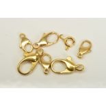 SEVEN SPRING RELEASE CLASPS, all with marks to indicate 18ct gold, lengths 7mm to 15mm,