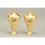 A PAIR OF ROYAL WORCESTER BLUSH IVORY TWIN HANDLED VASES, shape No.1674, printed and painted with