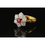 A LATE 20TH CENTURY RUBY AND DIAMOND ROUND CLUSTER RING, ruby measuring approximately 4.7mm in