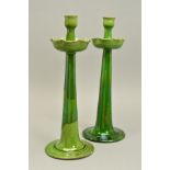 C.H. BRANNAM FOR LIBERTY & CO, a pair of earthenware candlesticks with fluted drip pans, decorated