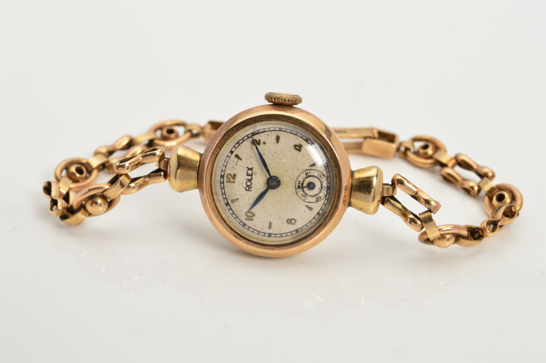 AN EARLY TO MID 20TH CENTURY 9CT GOLD LADIES ROLEX WRISTWATCH, refinished silvered dial signed '