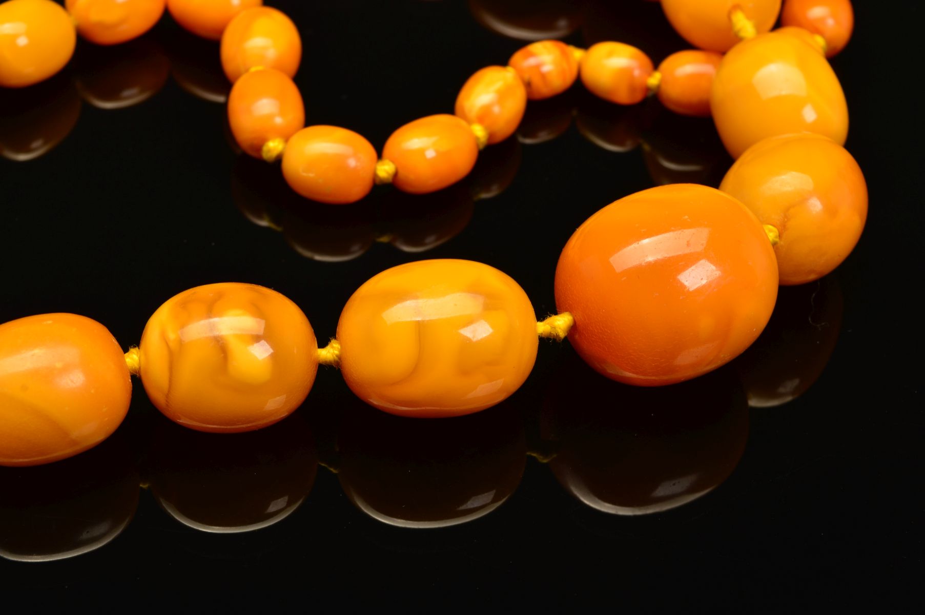 A LONG NATURAL AMBER BEAD NECKLACE, designed as sixty one graduated barrel shape butterscotch - Image 2 of 5