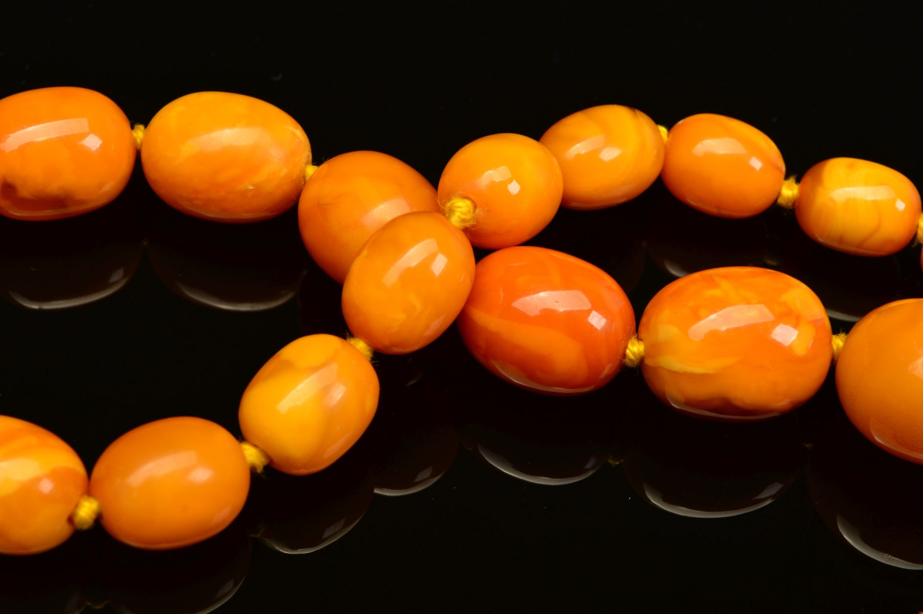 A LONG NATURAL AMBER BEAD NECKLACE, designed as sixty one graduated barrel shape butterscotch - Image 4 of 5