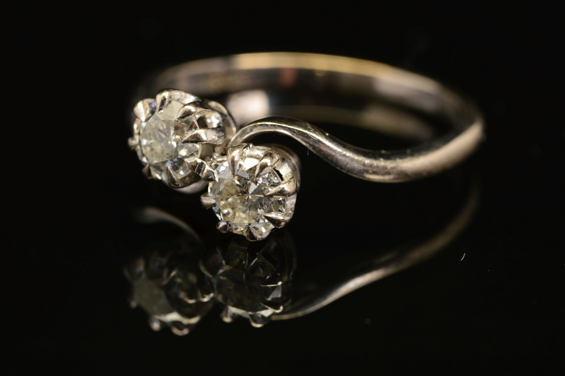 A MID 20TH CENTURY TWO STONE DIAMOND CROSS OVER RING, two brilliant cut diamonds each measuring
