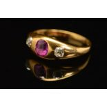 A VICTORIAN GOLD, RUBY AND DIAMOND THREE STONE RING, an oval mixed cut ruby measuring