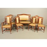AN EDWARDIAN MAHOGANY AND SATINWOOD INLAID SALON SUITE, comprising a salon settee, a pair of
