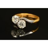 A TWO STONE CROSS OVER DIAMOND RING, two round brilliant cut diamonds, measuring approximately 5.2mm