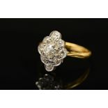 AN EARLY 20TH CENTURY DIAMOND CLUSTER RING, the central old cut diamond within a raised eight claw