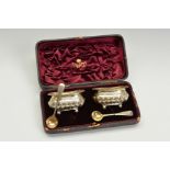 A CASED PAIR OF LATE VICTORIAN SILVER SALTS, of rectangular form, worn gilt interiors, part reeded