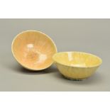 TWO RUSKIN POTTERY BOWLS, the first being a yellow and green crystalline example with impressed