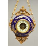 A LATE 19TH CENTURY GILT METAL AND PORCELAIN CASED CIRCULAR WALL HANGING CLOCK, the blue ground with