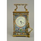 AN EARLY 20TH CENTURY FRENCH BRASS AND CHAMPLEVE ENAMEL CARRIAGE CLOCK, cream enamel dial, s.d.,