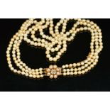 A THREE ROW GRADUATED NATURAL SEA WATER PEARL NECKLACE, strung knotted to a three row pearl and