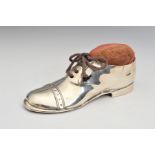 A GEORGE V SILVER PIN CUSHION, in the form of a Brogue type shoe, with real brown lace, wooden