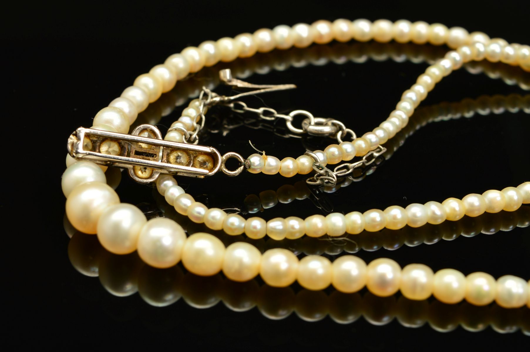 AN EARLY 20TH CENTURY NATURAL SALTWATER PEARL GRADUATED SINGLE ROW PEARL NECKLACE, accompanied by - Image 6 of 7