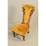 A VICTORIAN WALNUT FRAMED NURSING CHAIR, the tapering back with open scrolled foliate uprights,