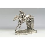 AN ELIZABETH II FILLED SILVER SCULPTURE OF A FIGURE GROUP OF A HORSE AND JOCKEY KNOWN AS 'OVER THE