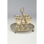 A VICTORIAN SILVER EGG CUP STAND, with four egg cups, all pieces with beaded rims and engraved