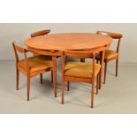 GREAVES AND THOMAS, a 1970's teak oval extending dining table, one additional fold out leaf, width