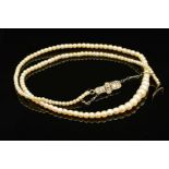 AN EARLY 20TH CENTURY NATURAL SALTWATER PEARL GRADUATED SINGLE ROW PEARL NECKLACE, accompanied by